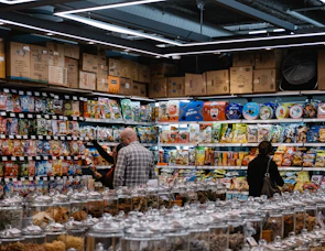 A busy aisle filled with colorful packages of Asian spices and sauces.