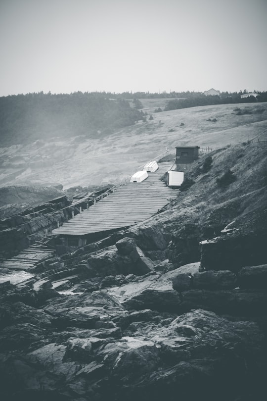 gray scale photo of a house on a hill in Pouch Cove Canada