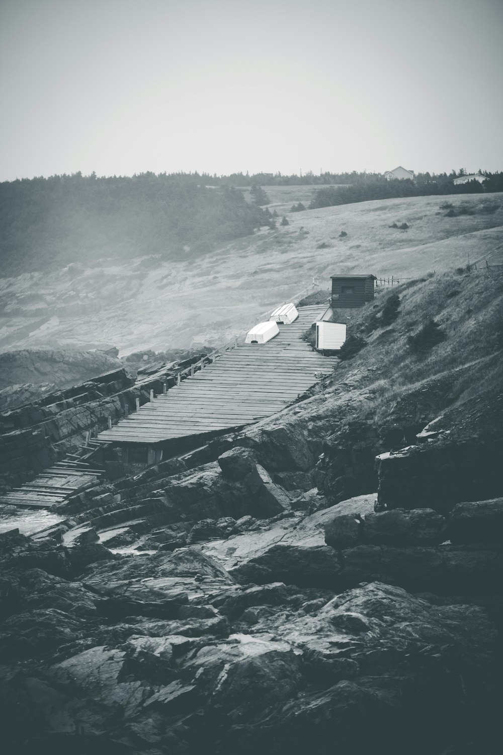 gray scale photo of a house on a hill