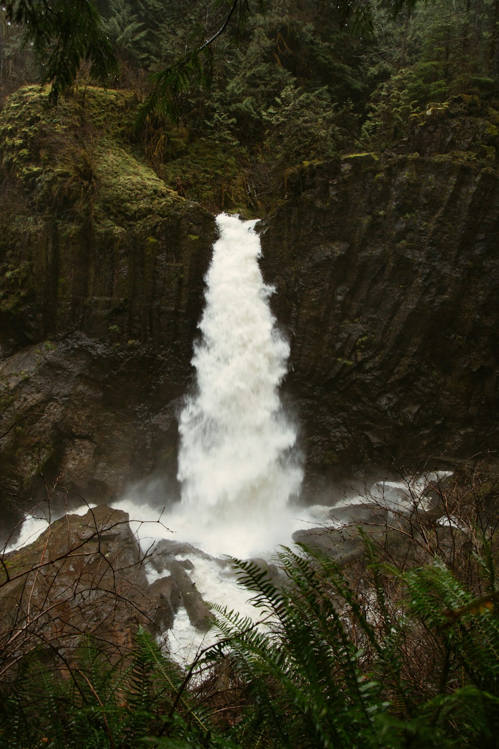 waterfalls on rocky mountain during daytime