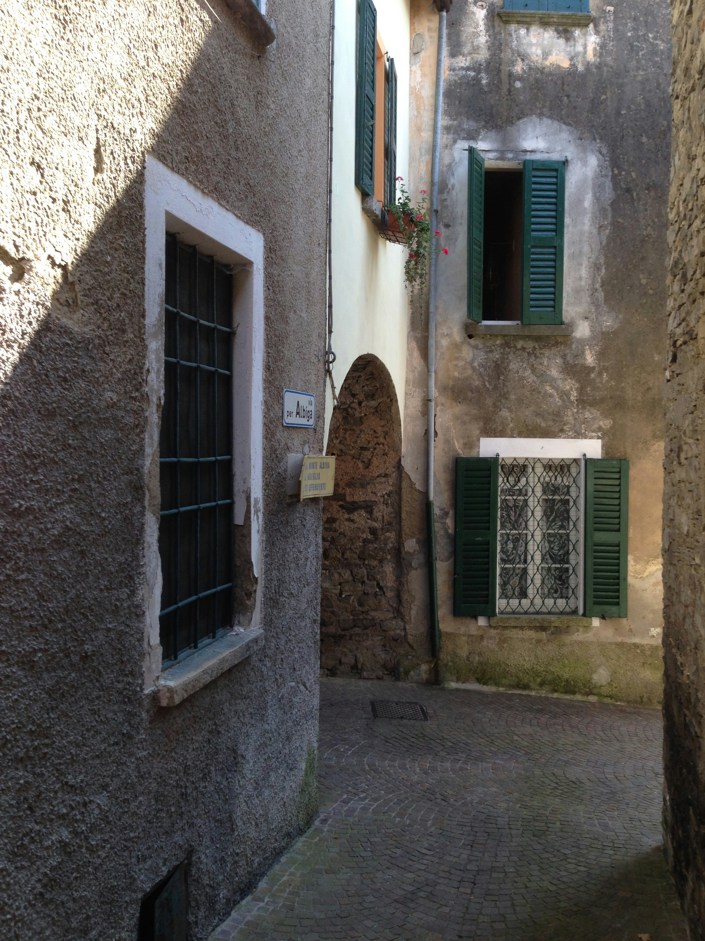 green wooden window on brown concrete building