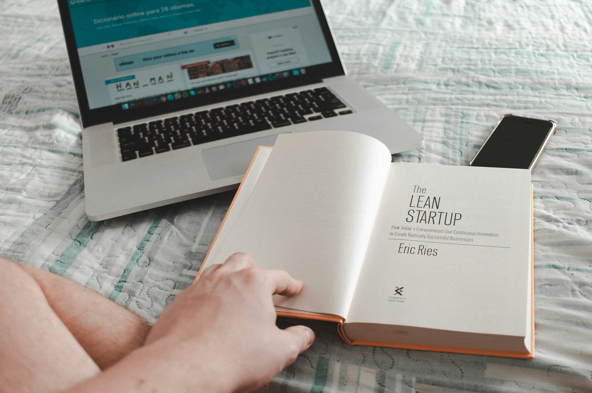 Young boy reading the book "The Lean Startup", by Eric Ries