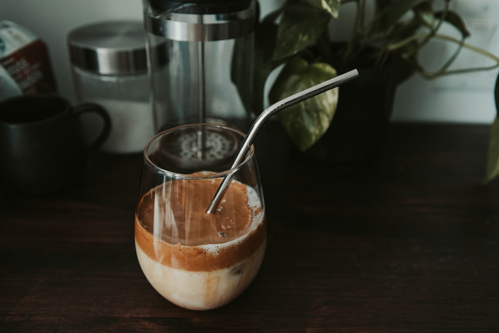 clear drinking glass with brown liquid inside