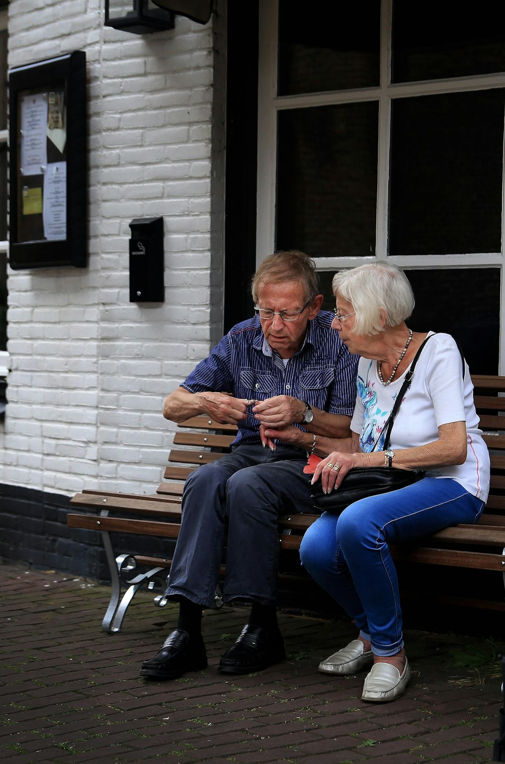 a man and a woman sitting on a bench