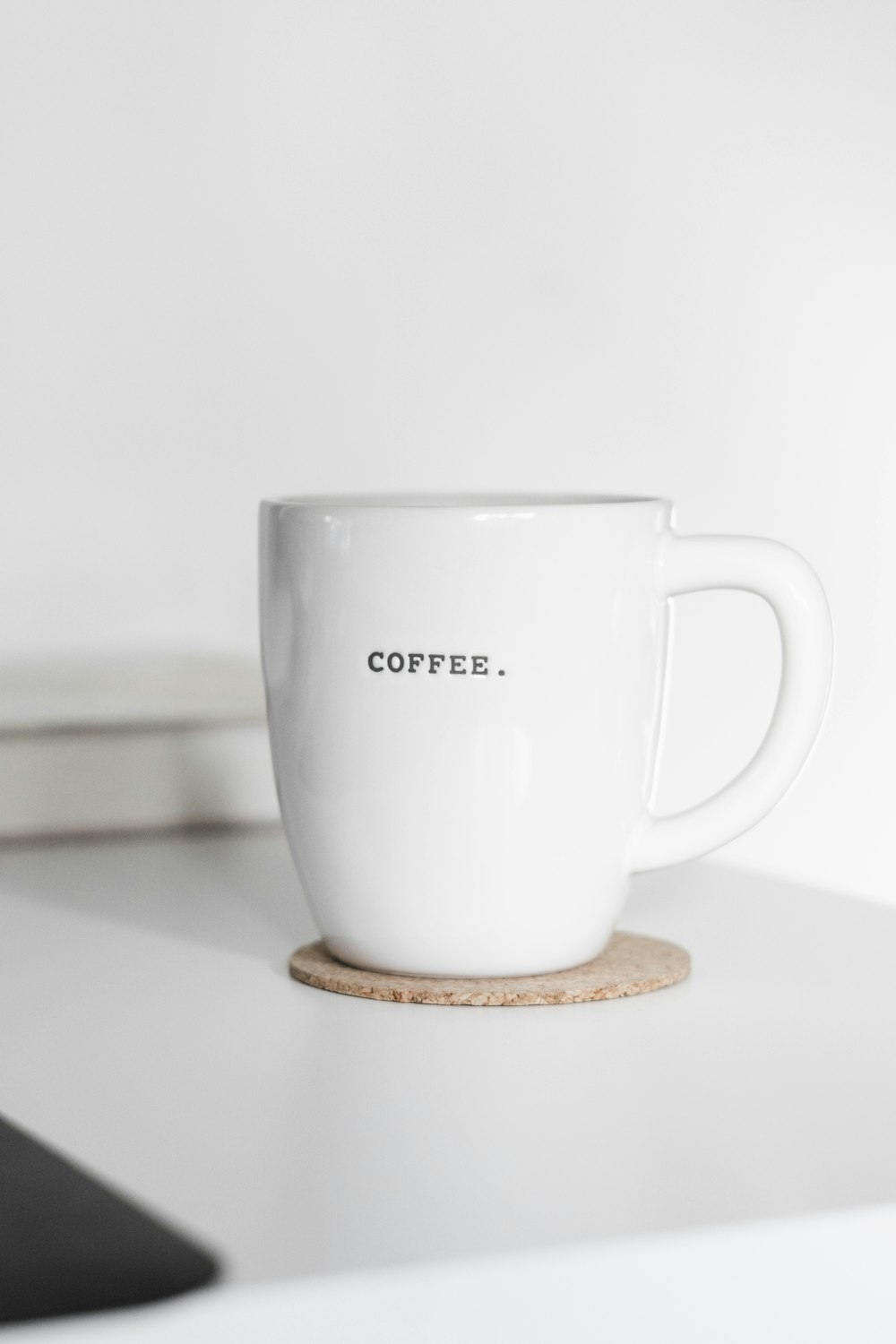 white ceramic mug on brown wooden coaster