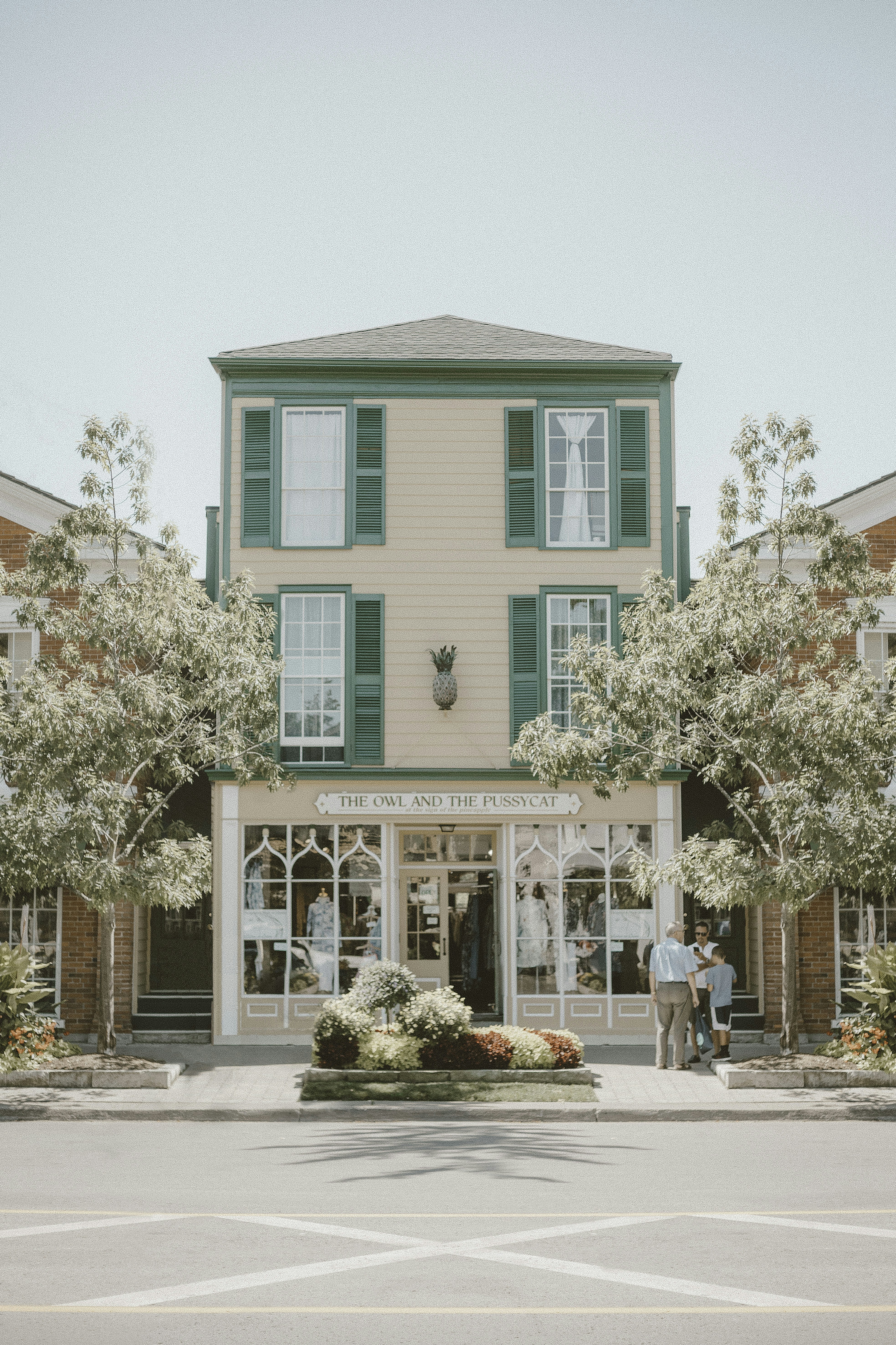 cars parked in front of teal and white concrete building during daytime