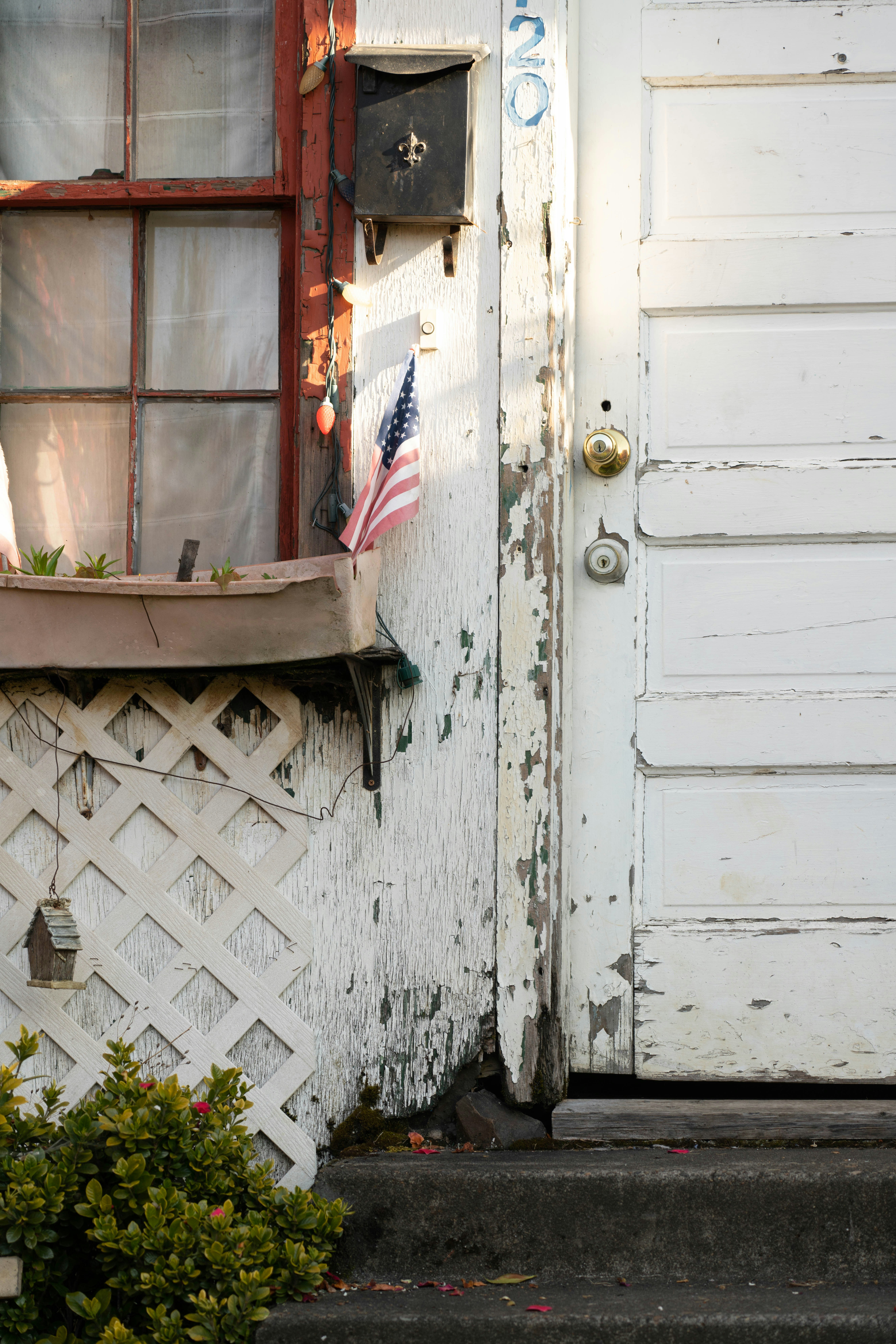 white wooden door with white metal fence
