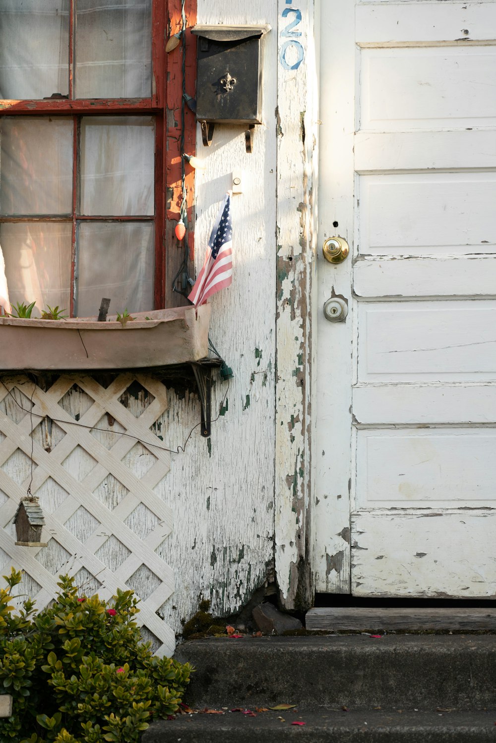 white wooden door with white metal fence