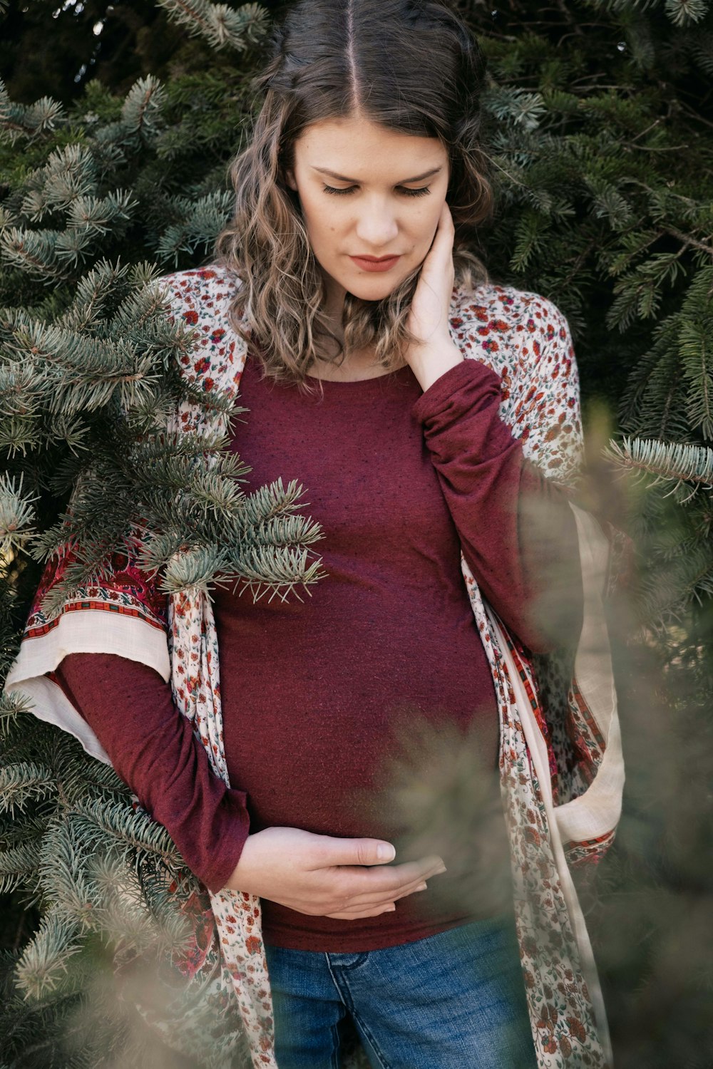 woman in red long sleeve shirt and red and white pants sitting on green christmas tree