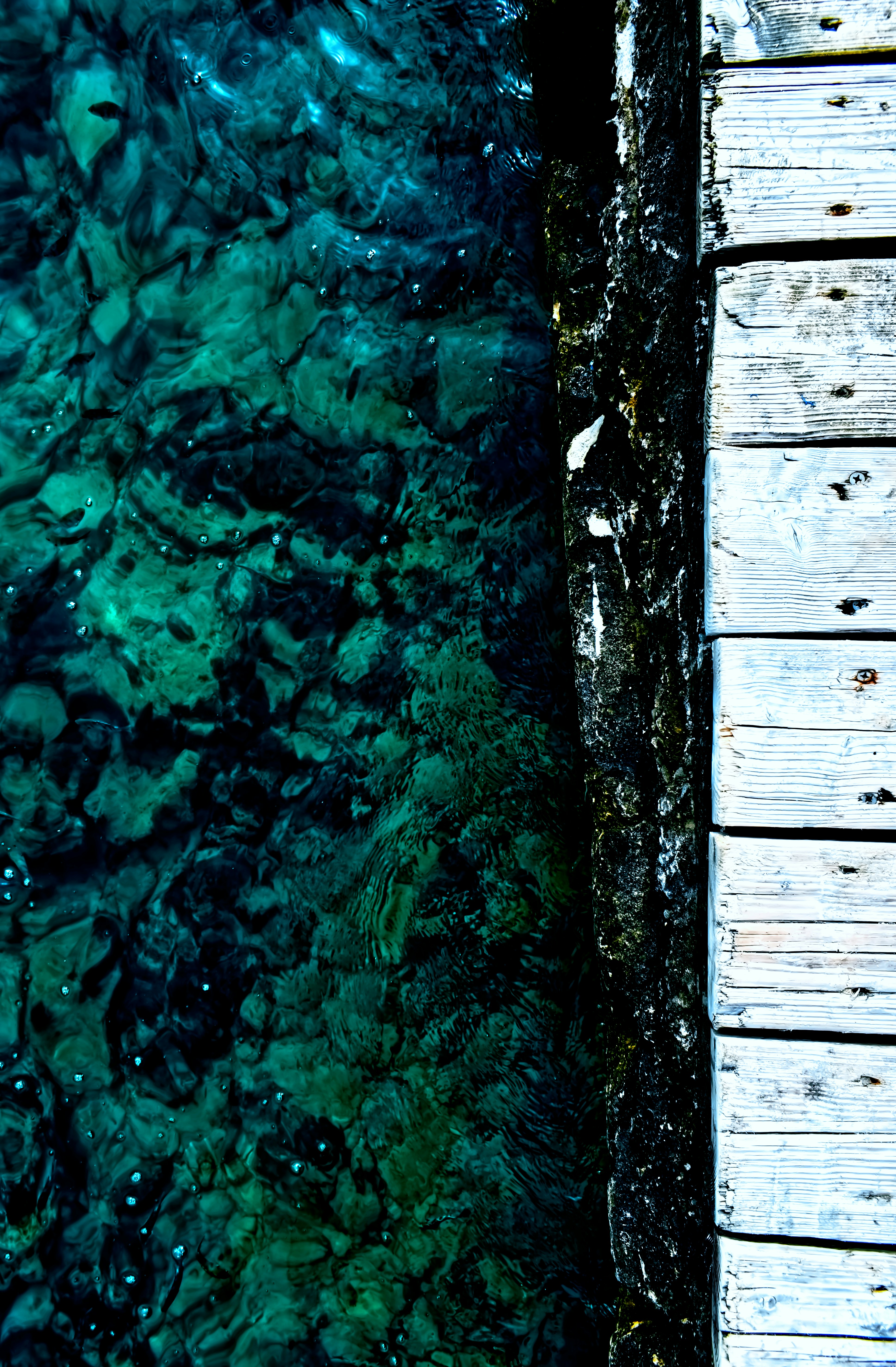 brown wooden plank on body of water