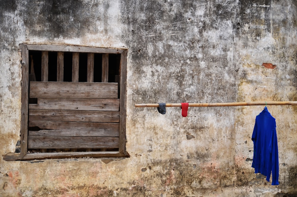 red and black metal rod on brown wooden wall