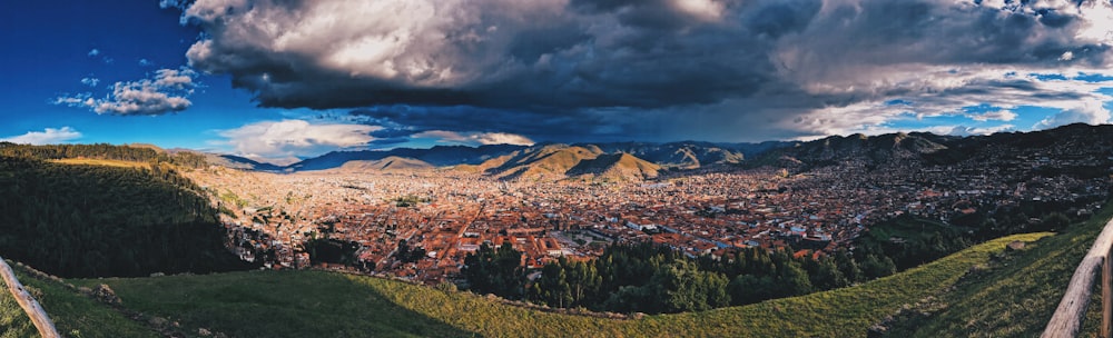 green and brown mountains under white clouds and blue sky during daytime