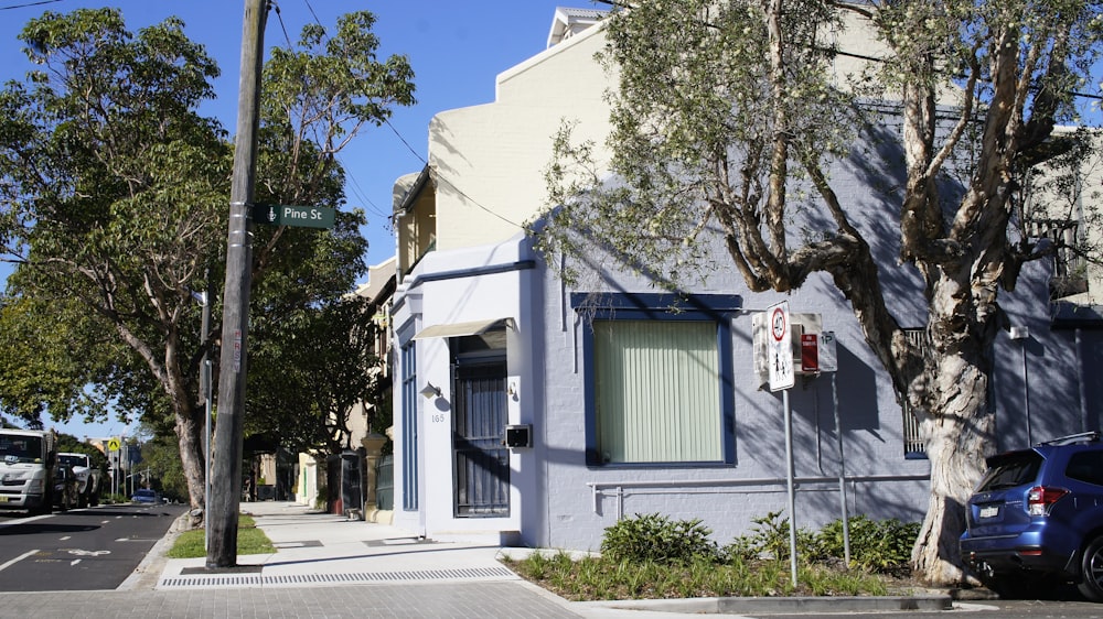 blue and white concrete house near green trees during daytime