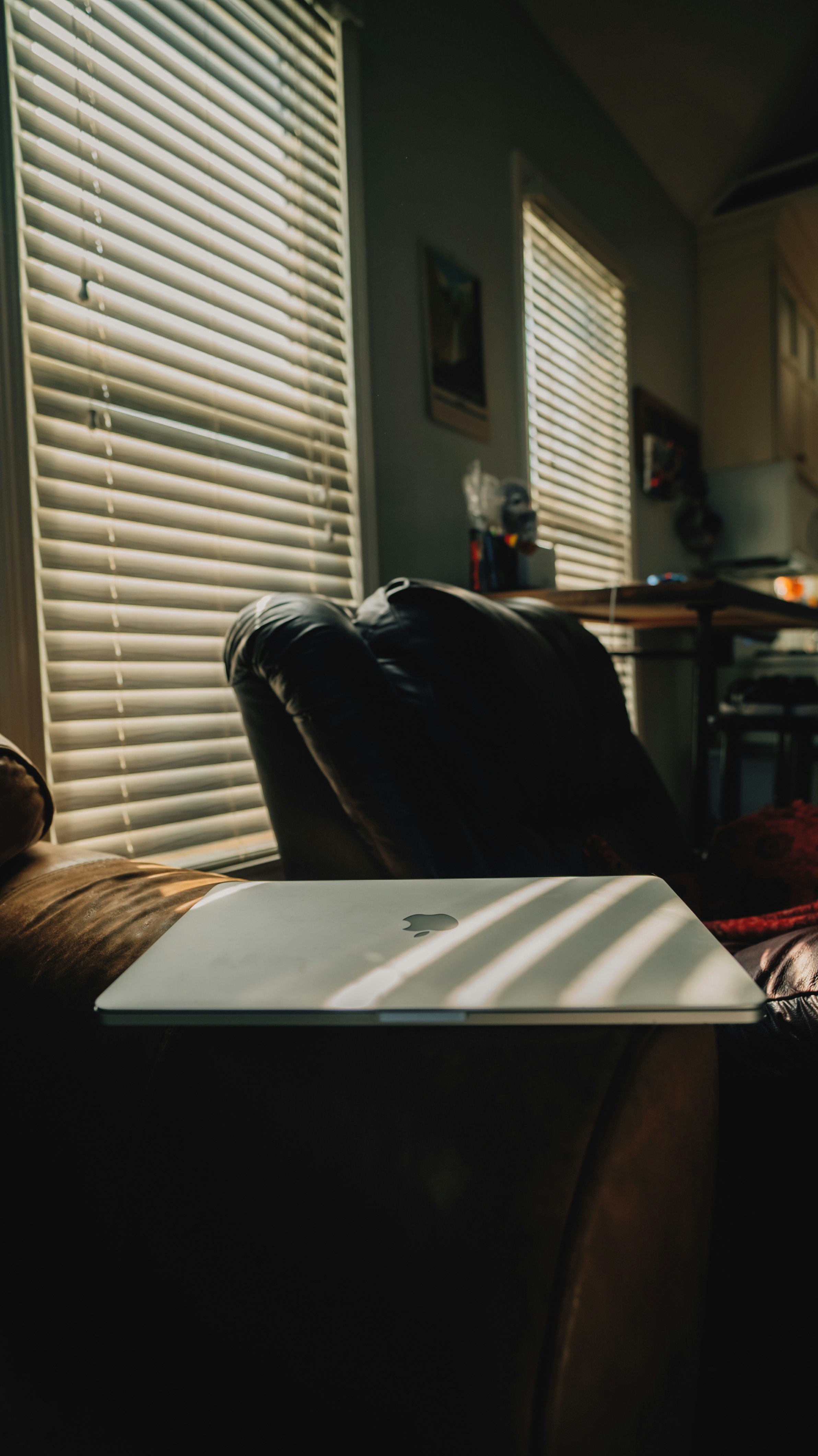 silver macbook on brown wooden table