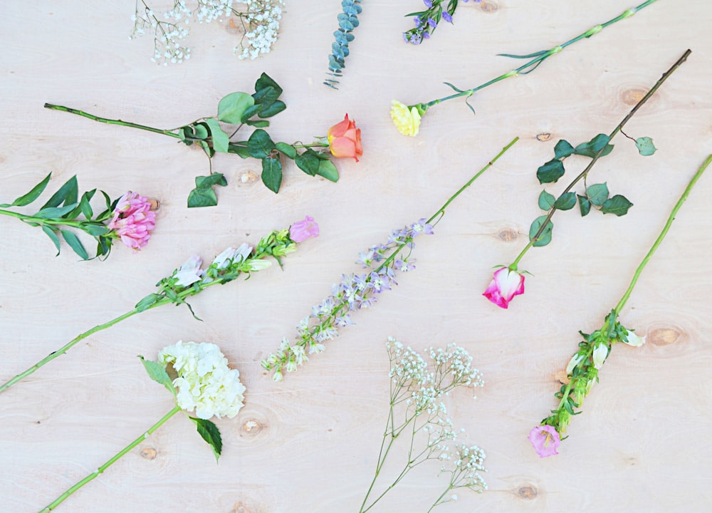 white and pink flowers on white wooden table