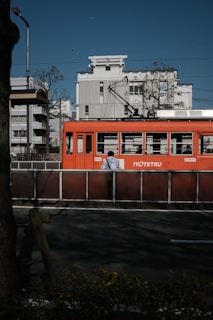 red and white train on rail road during daytime