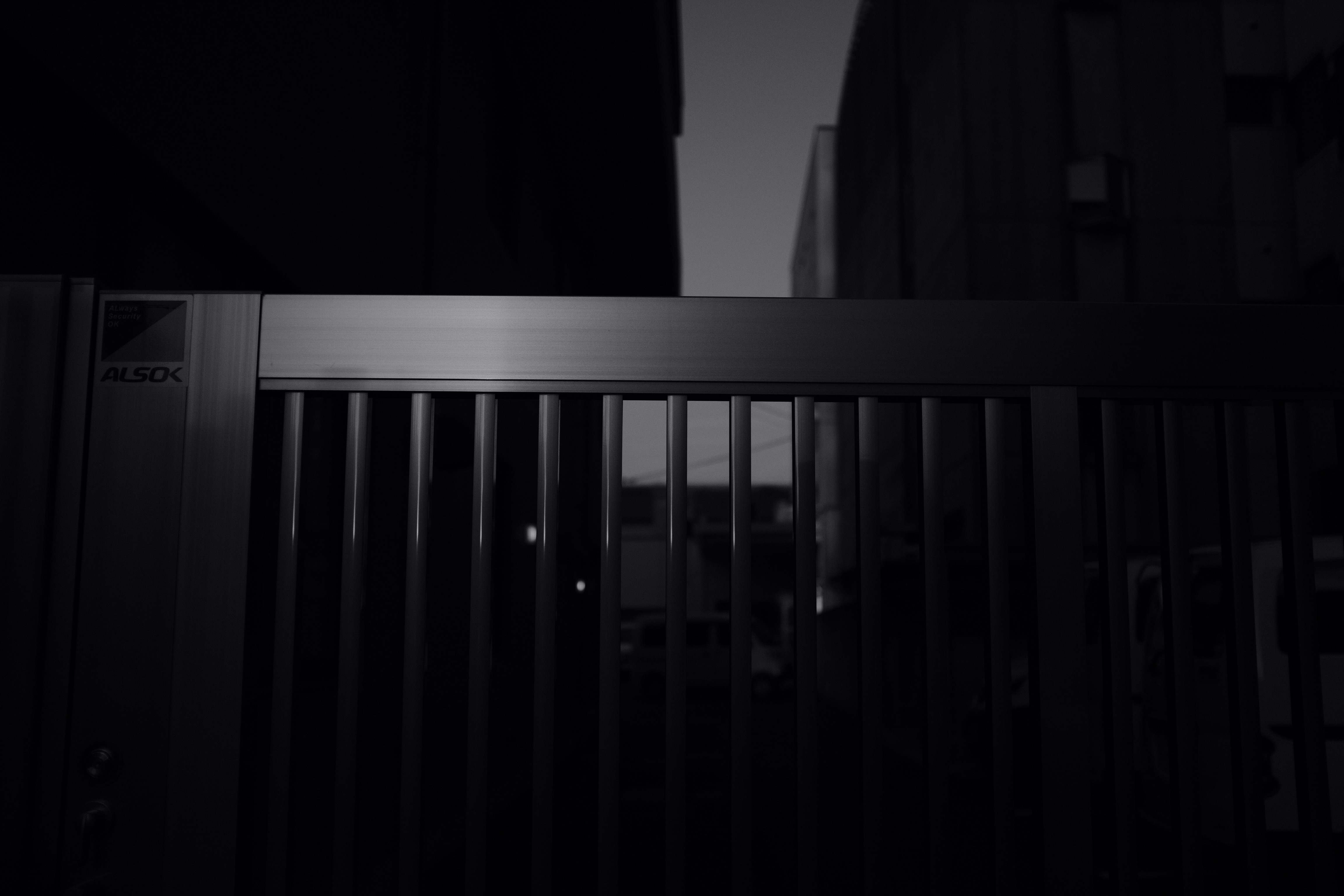 gray scale photo of wooden fence