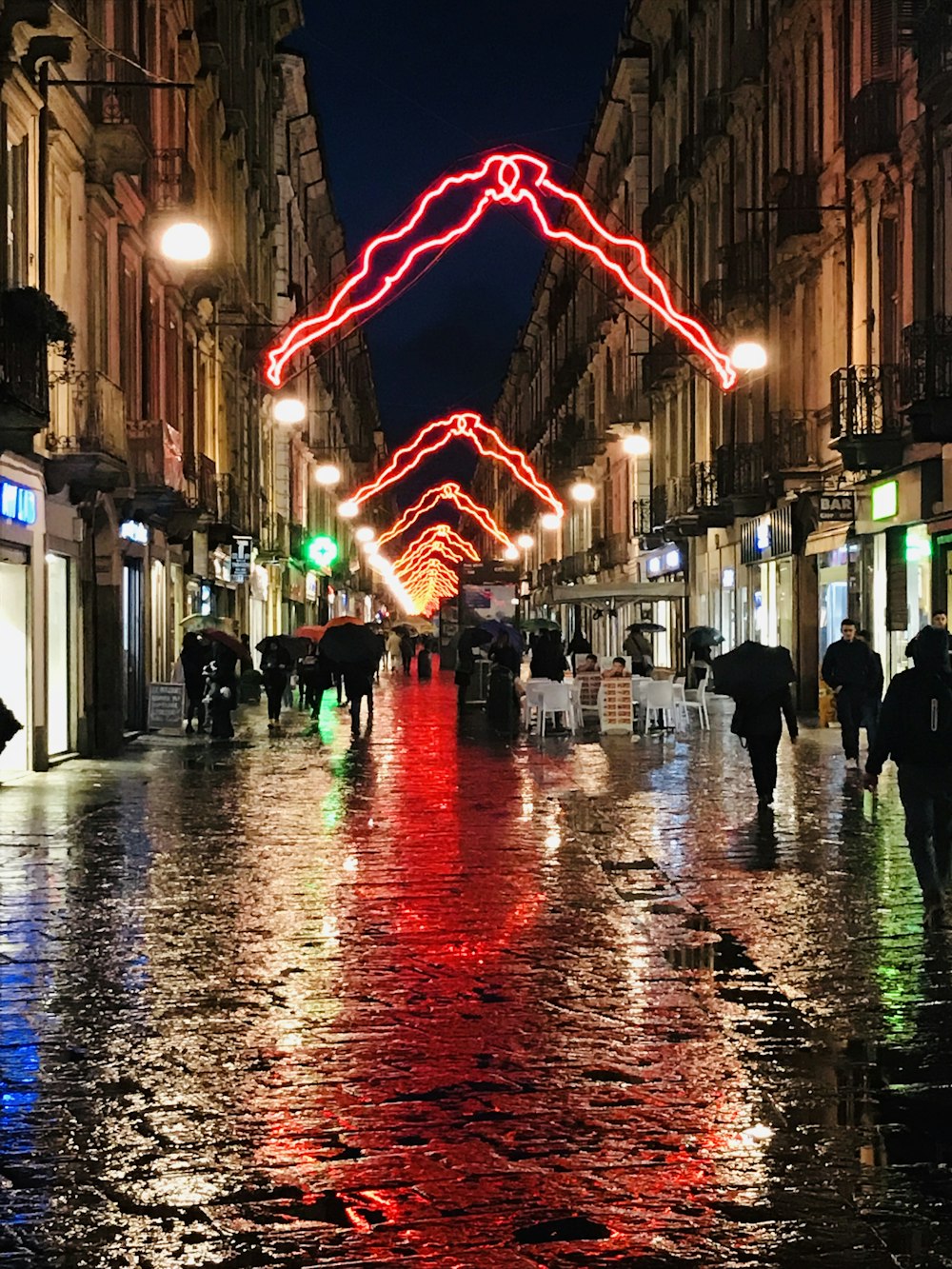 people walking on street during night time