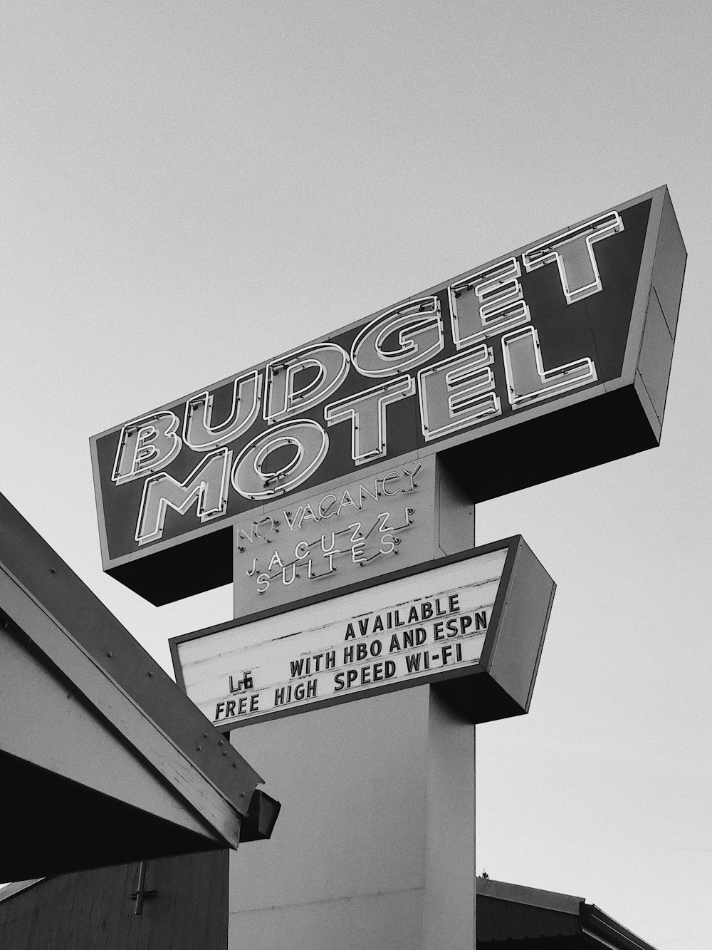 a black and white photo of a hotel sign