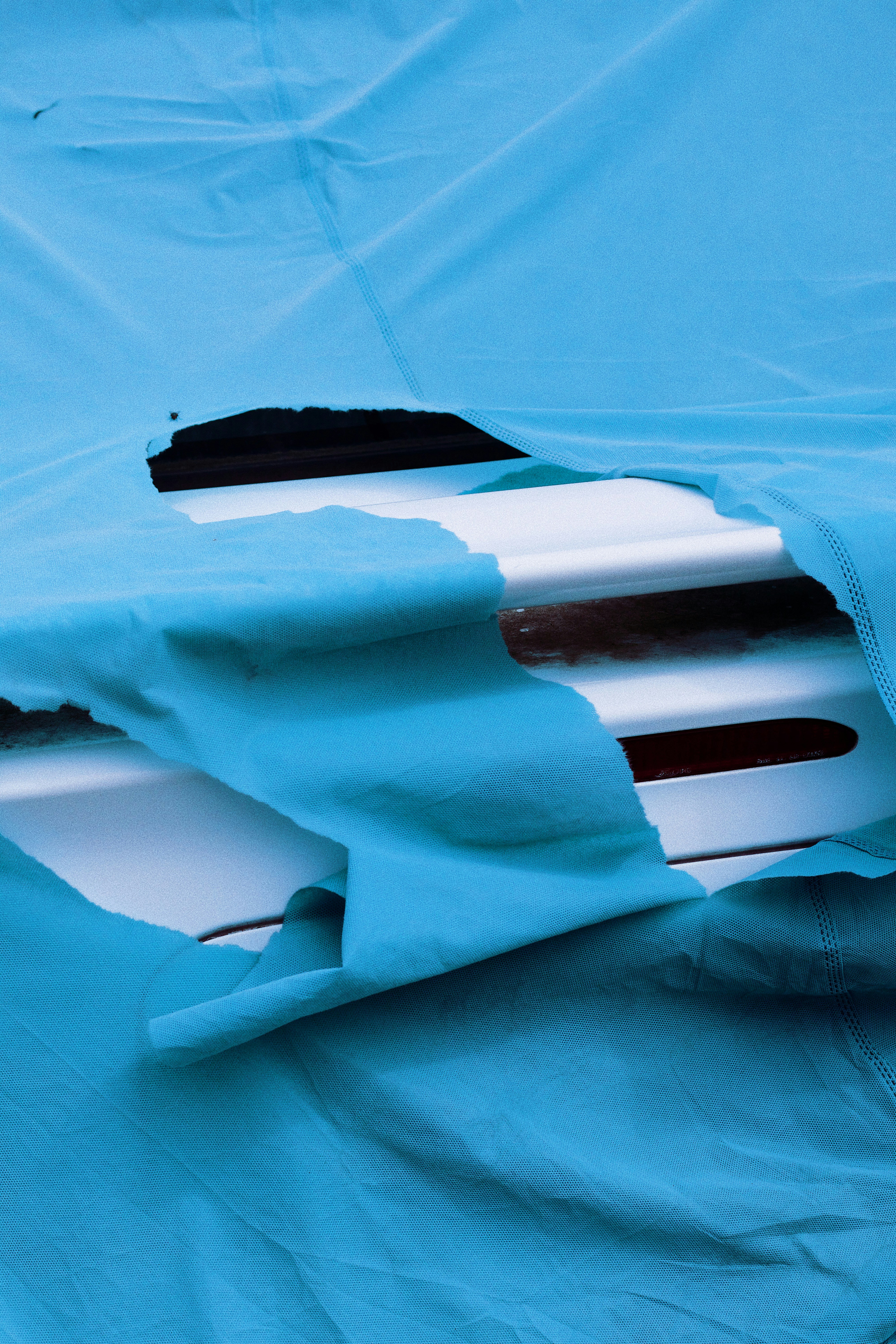 black and white rectangular device on blue textile