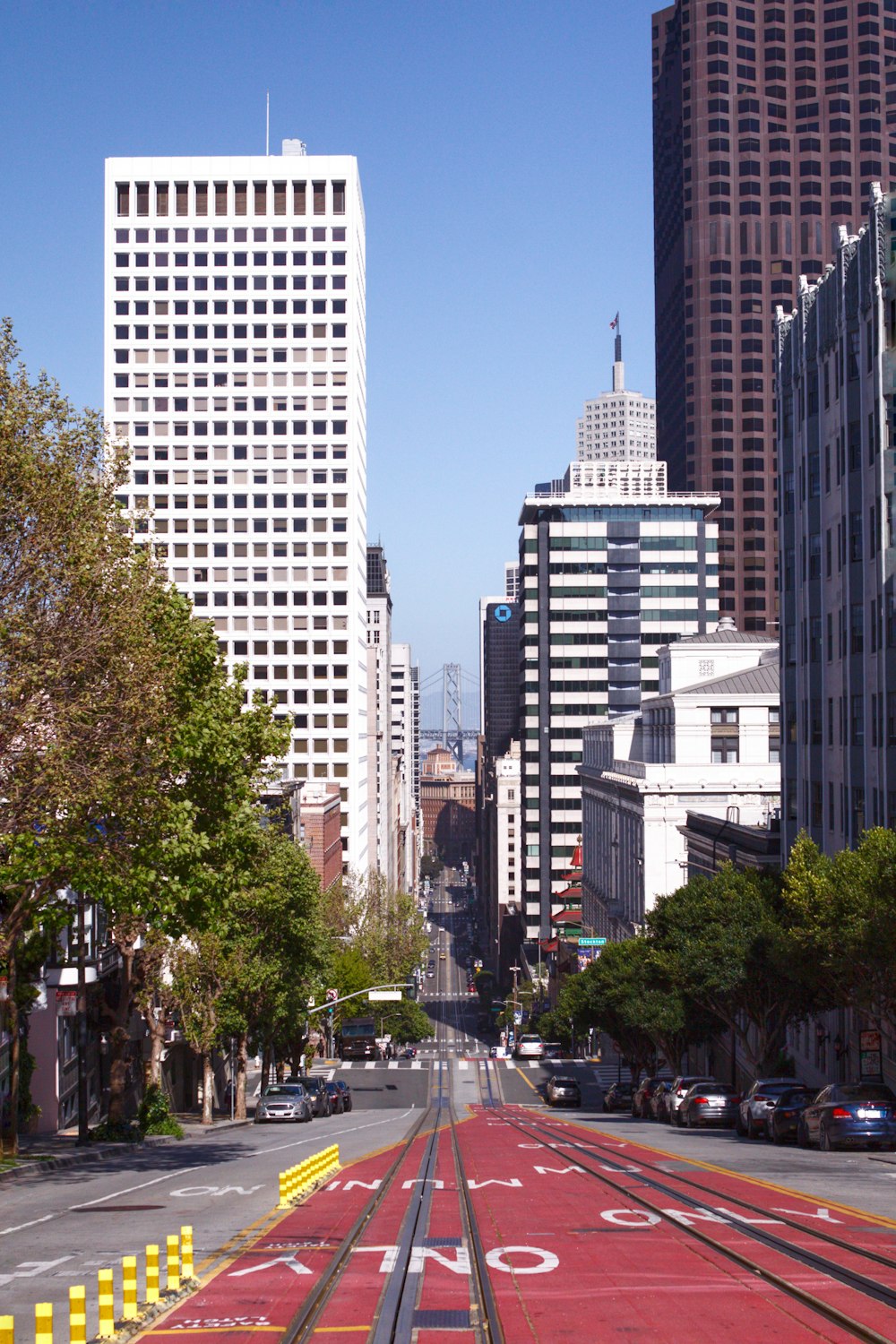 cars on road near high rise buildings during daytime