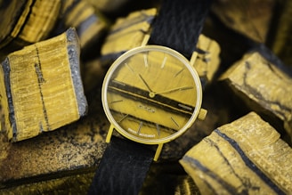 Elegant women showing their wrists with quartz watches in yellow, black, and white tones