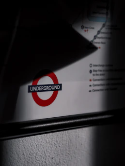 A partially shadowed section of a travel map includes a prominent symbol featuring a red circle with the word 'Underground' in blue. Lines and text details appear around the symbol.