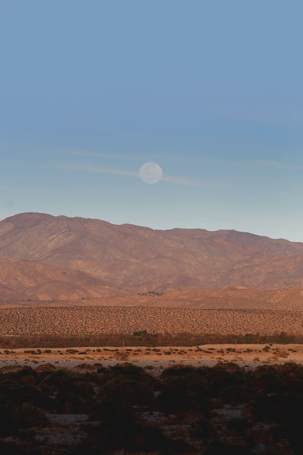 Brown desert mountains under a blue sky