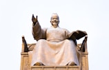 grey concrete statue under white sky during daytime