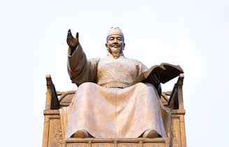 grey concrete statue under white sky during daytime