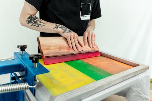 person in black t-shirt holding brown wooden board