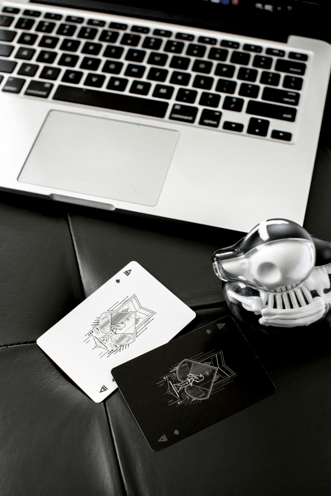 macbook pro beside white and black ceramic teapot