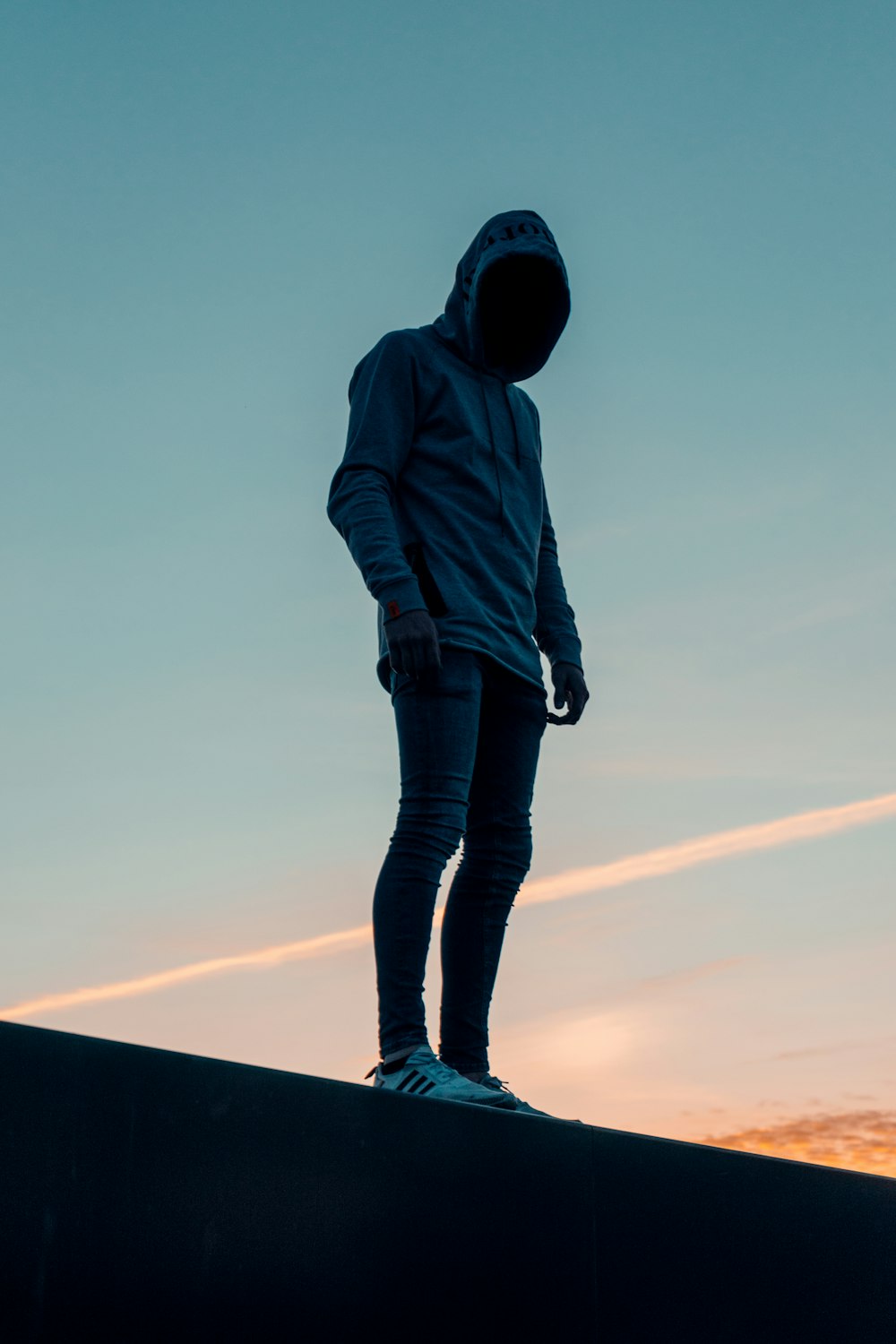 woman in brown hoodie standing on top of the building