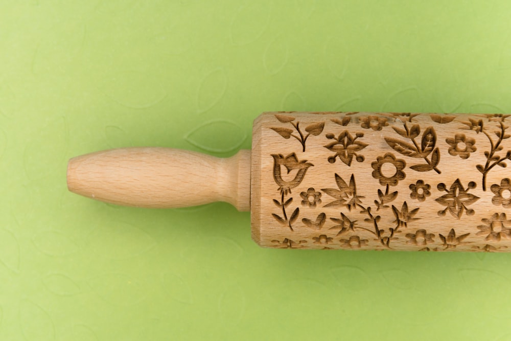 brown and beige floral wooden hand tool