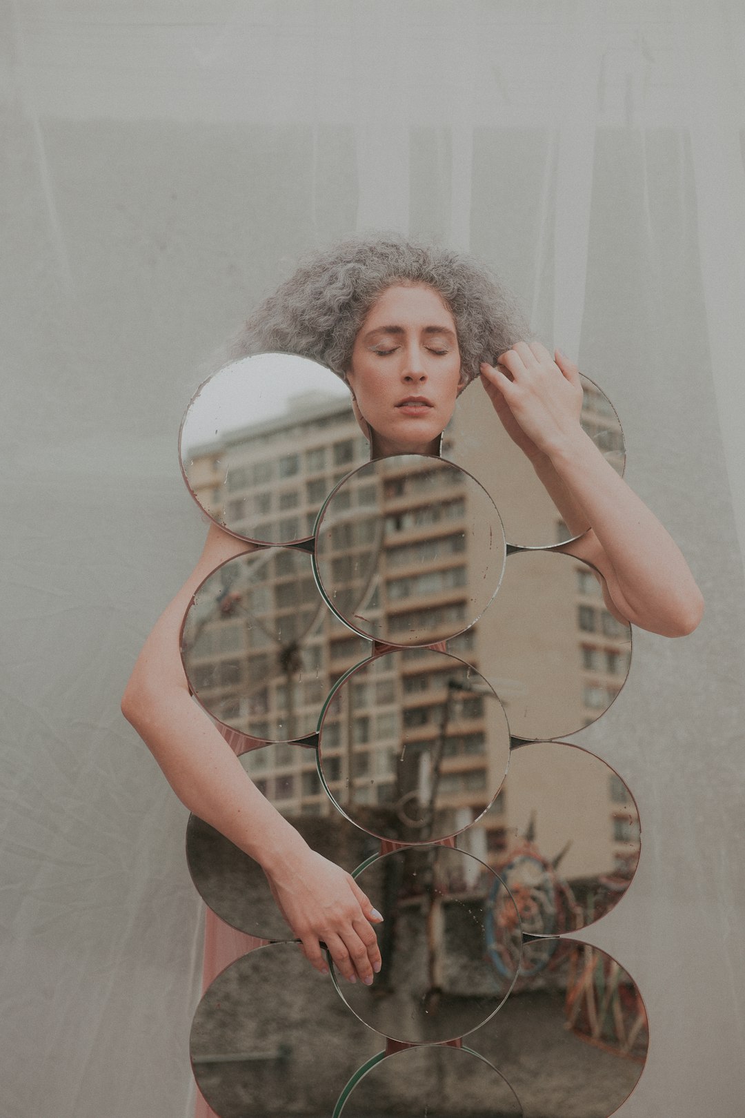 woman in black tank top holding mirror