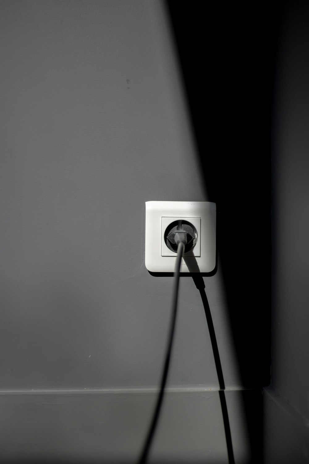 black electric plug on white socket