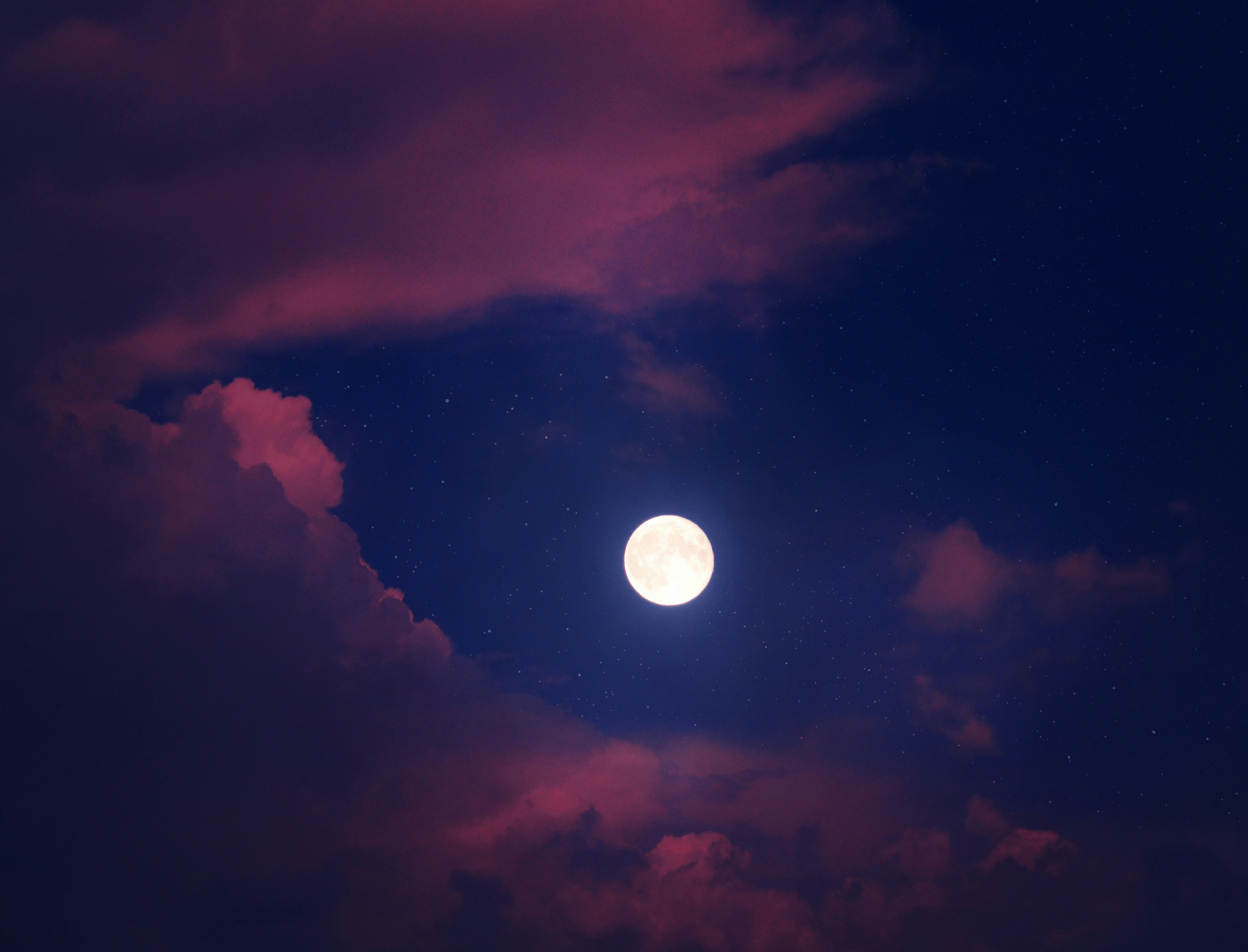 full moon over dark clouds