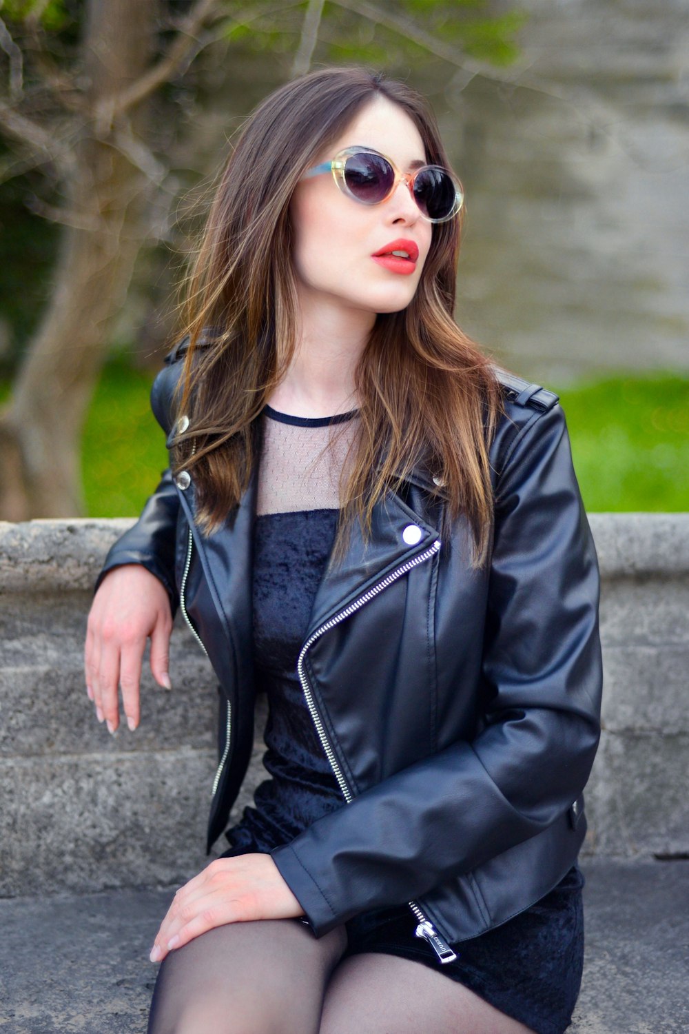 woman in black leather jacket and black framed sunglasses
