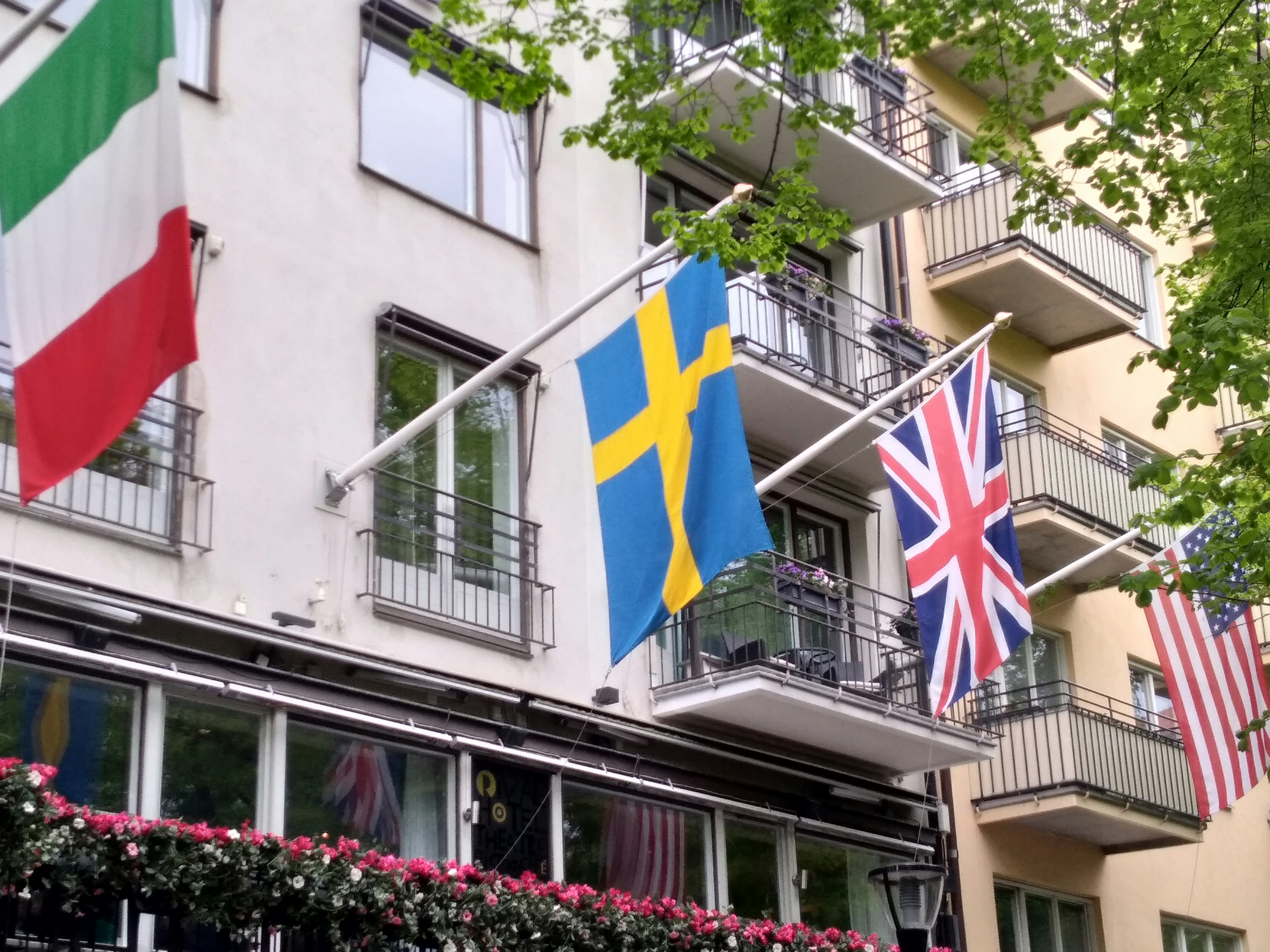 flags on poles on building during daytime