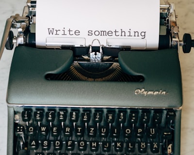 black and white typewriter on green table