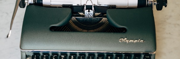 black and white typewriter on green table