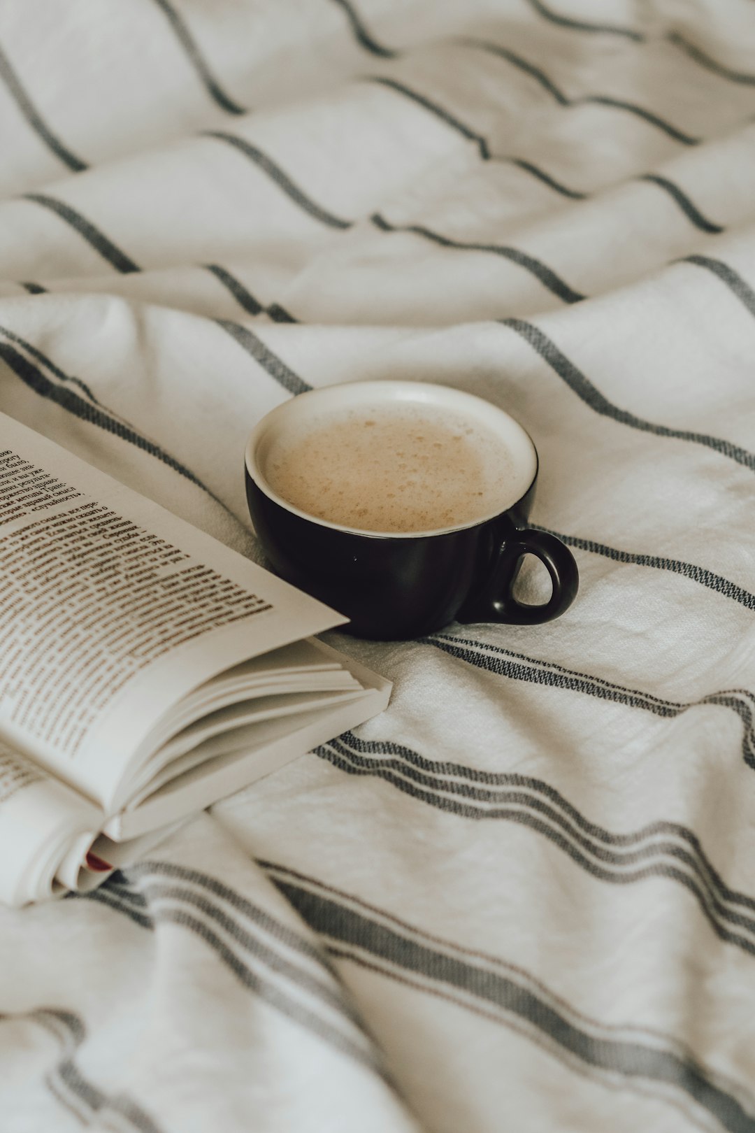 black ceramic mug on book page