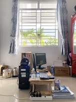 Professional setting up a laptop in a well-appointed temporary apartment.