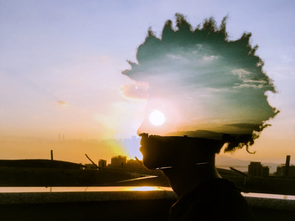 silhouette of man wearing hat during sunset