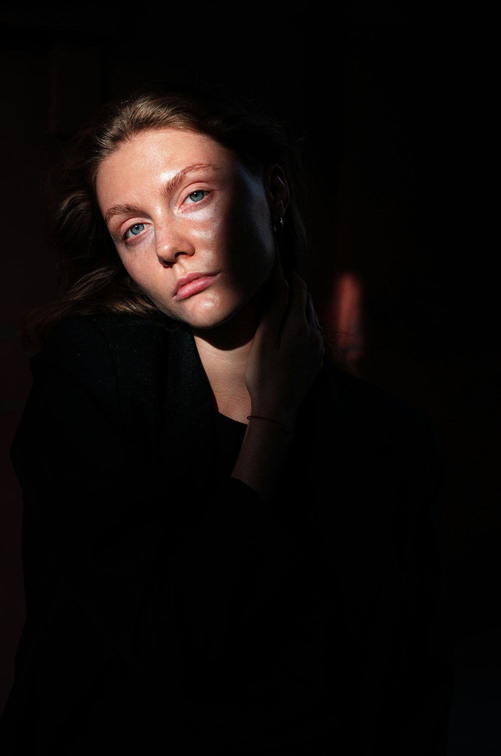 woman in black blazer with brown hair