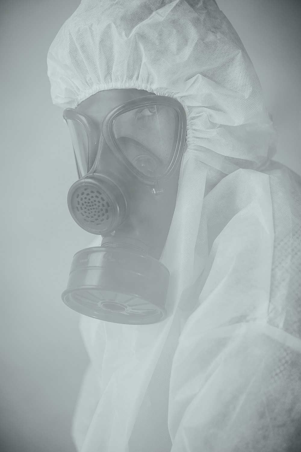 person wearing gas mask in grayscale photography