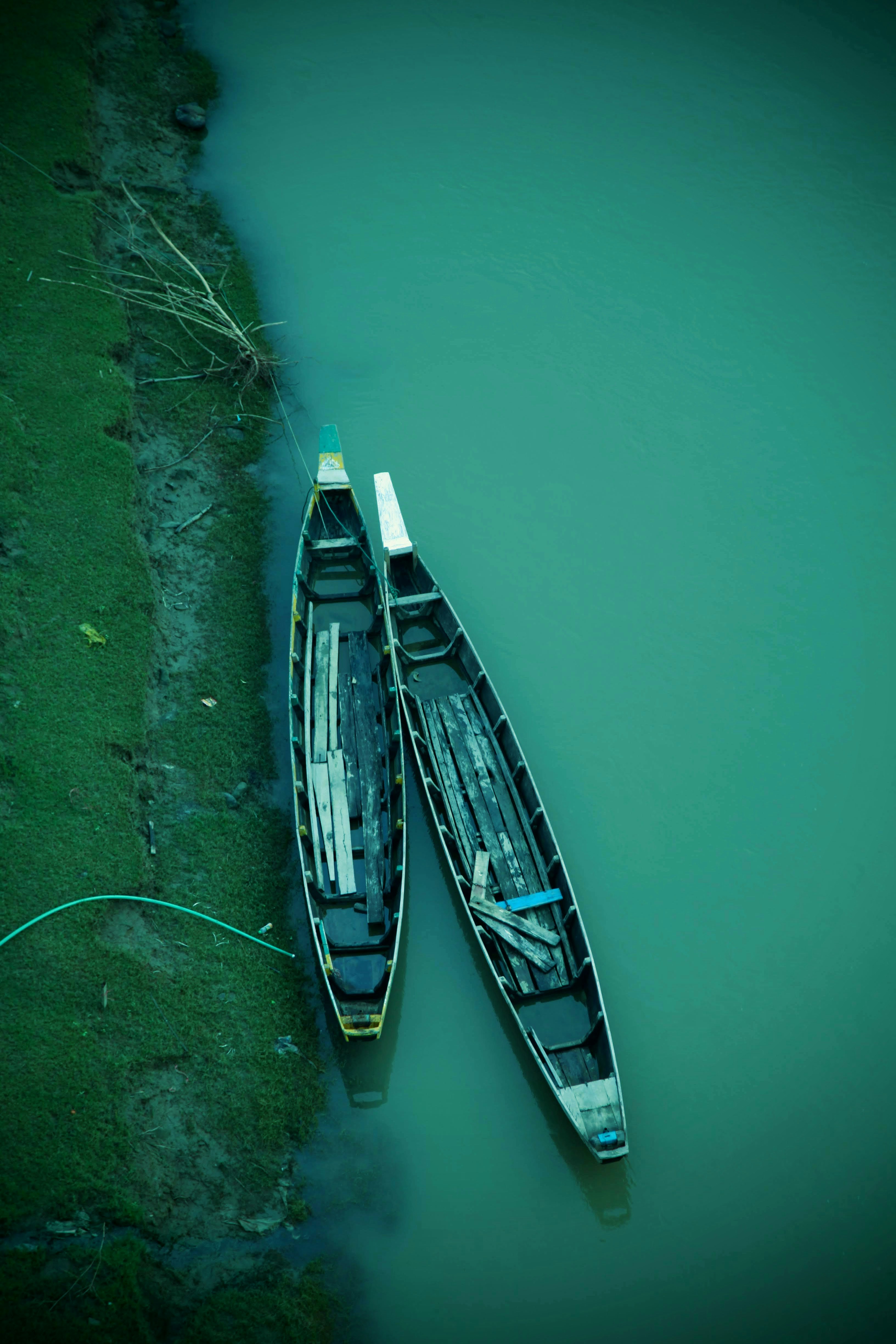 white and blue boat on body of water during daytime