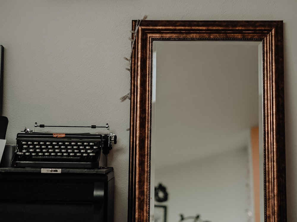 black typewriter on brown wooden table