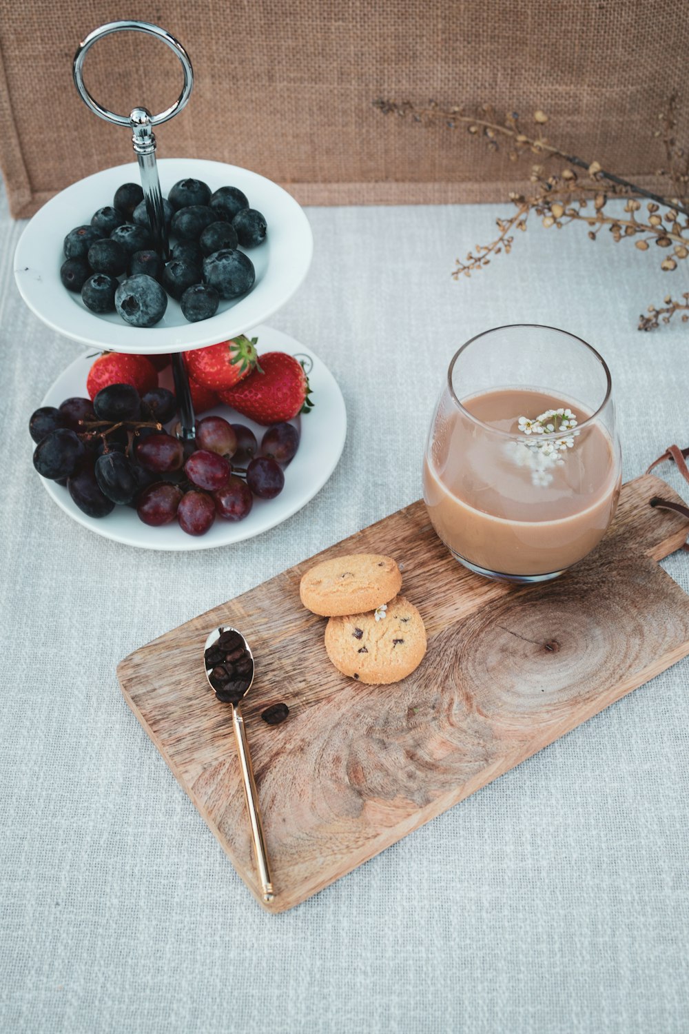 clear drinking glass with orange liquid on brown wooden chopping board