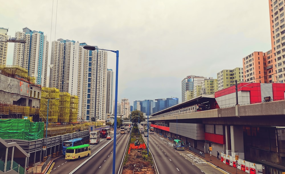 cars on road near high rise buildings during daytime